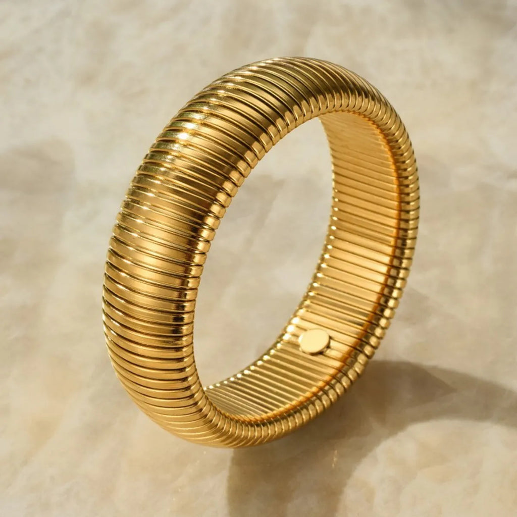 Women's elastic titanium steel bracelet with vertical stripe ring design in gold finish