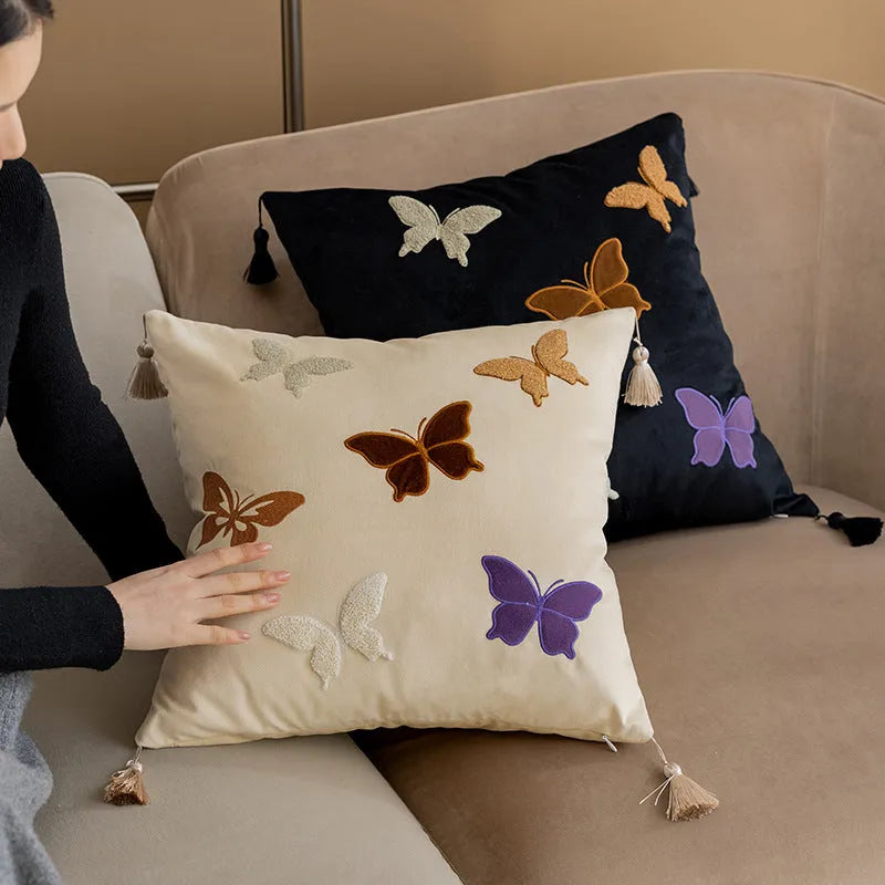 Square beige, black, and purple cushion with embroidered Chinese butterfly pattern.