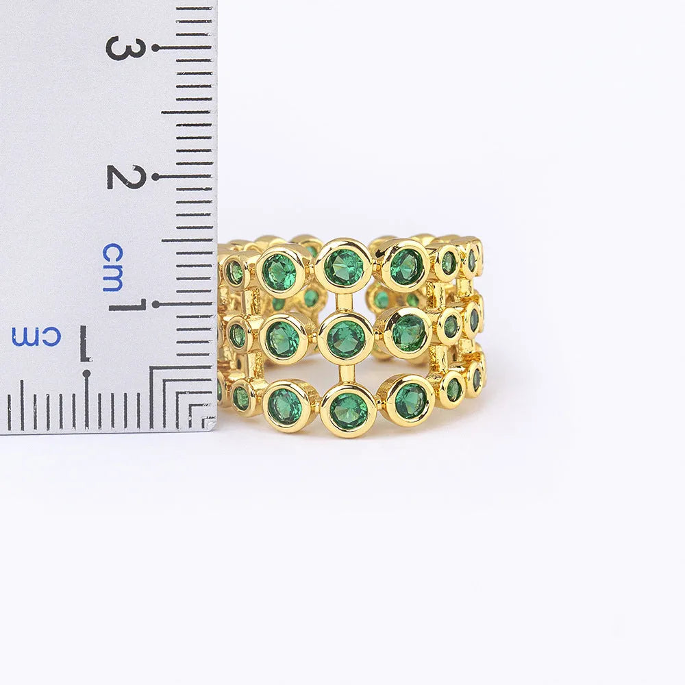 Copper wide band ring with 18K gold plating, green accents, and zircon stones