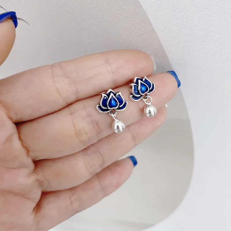 Blue lotus earrings with flower-shaped studs and artistic lotus seedpod tassel dangle