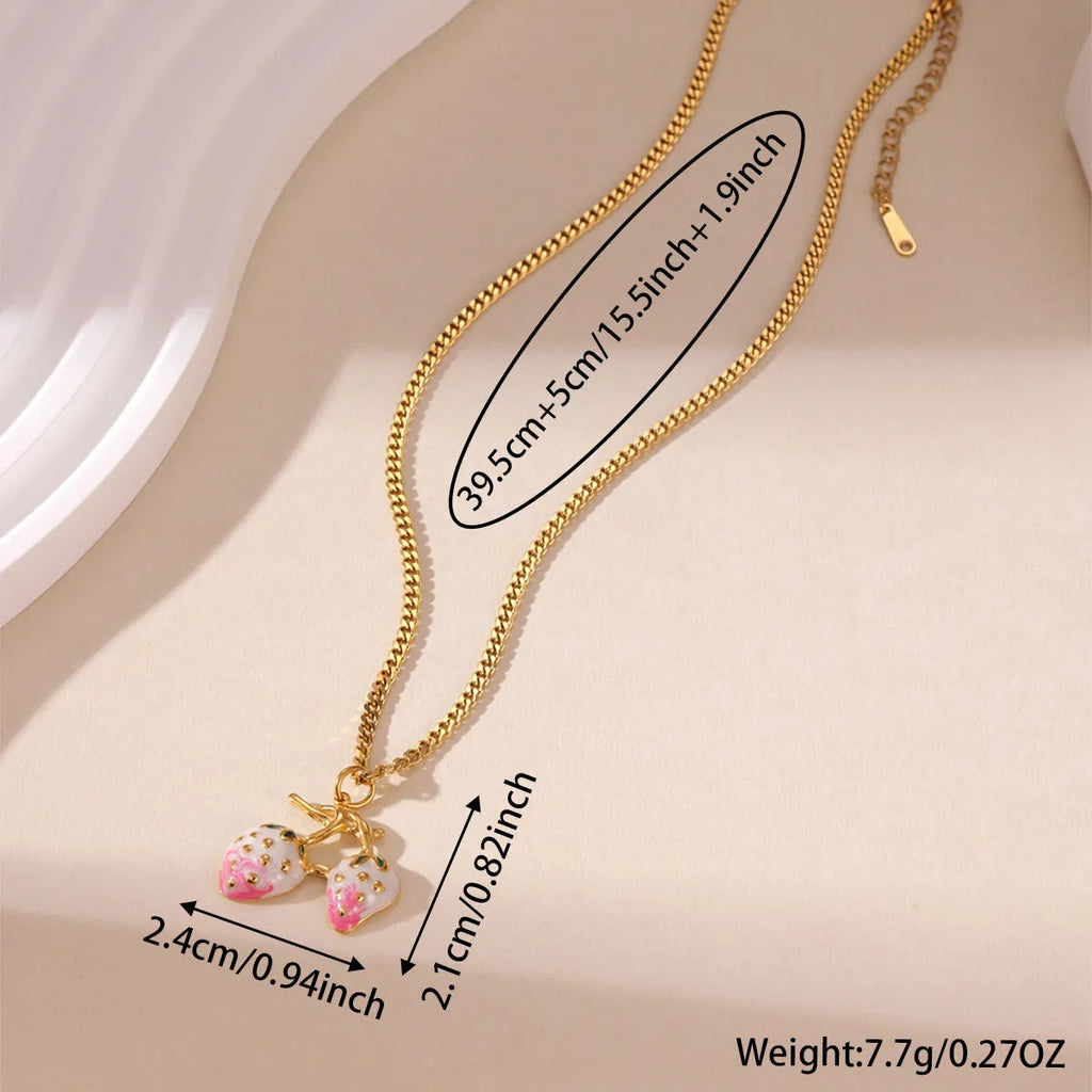 Close-up of a women's strawberry fruit pendant necklace with a detailed alloy charm on a stainless steel chain.