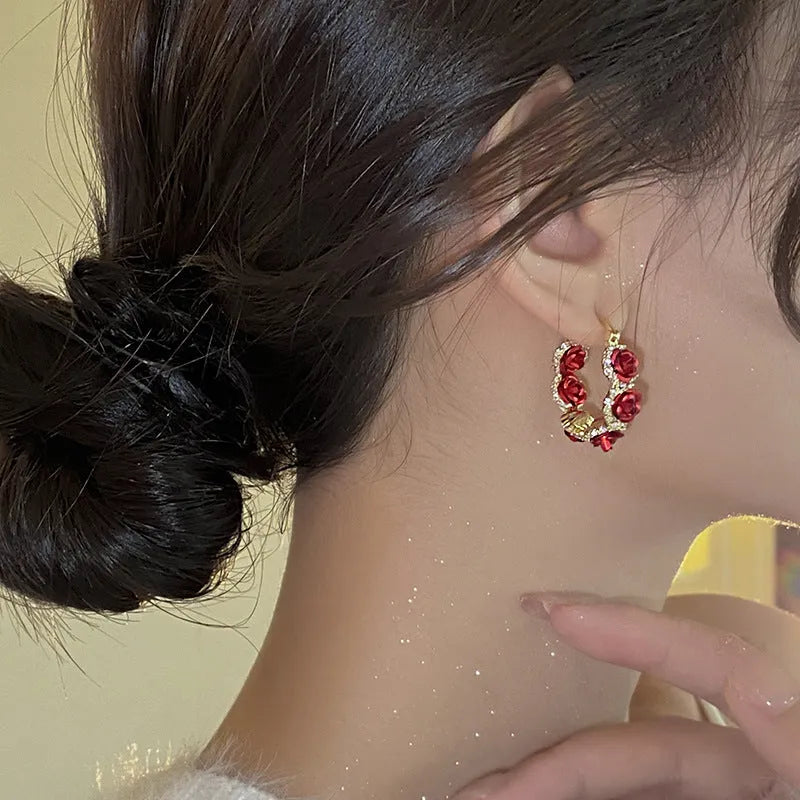 Red floral alloy ear clips with rose design and clip fastening
