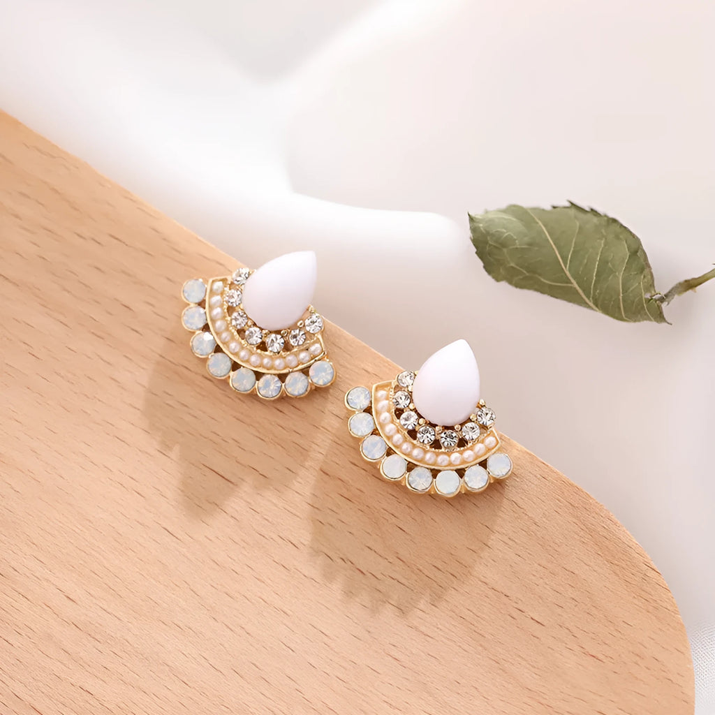 A pair of silver-toned retro fan-shaped drop earrings with a needle opal centre and sparkling rhinestone details.