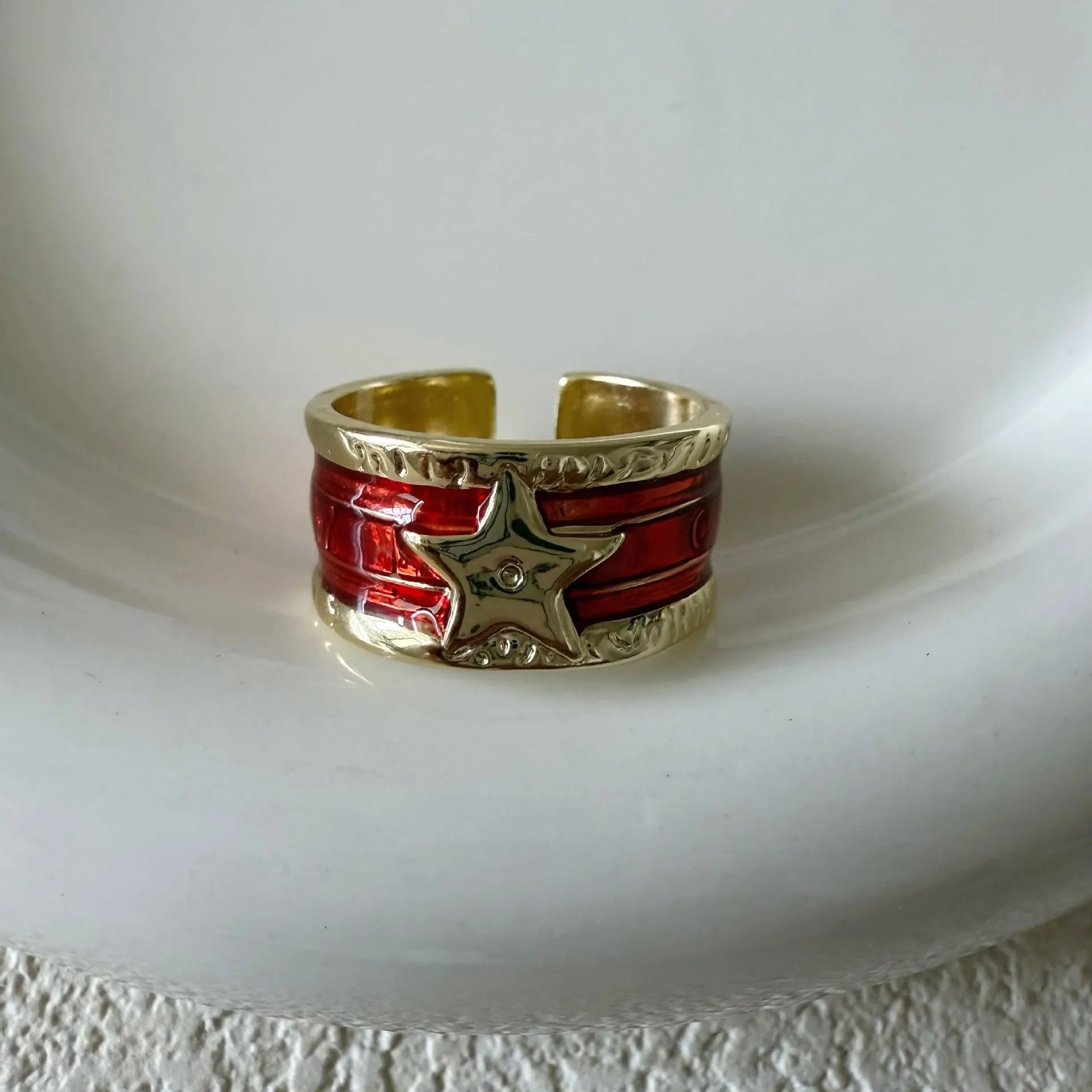 Adjustable geometric oil drop ring in distressed retro finish on copper, showing colour options.