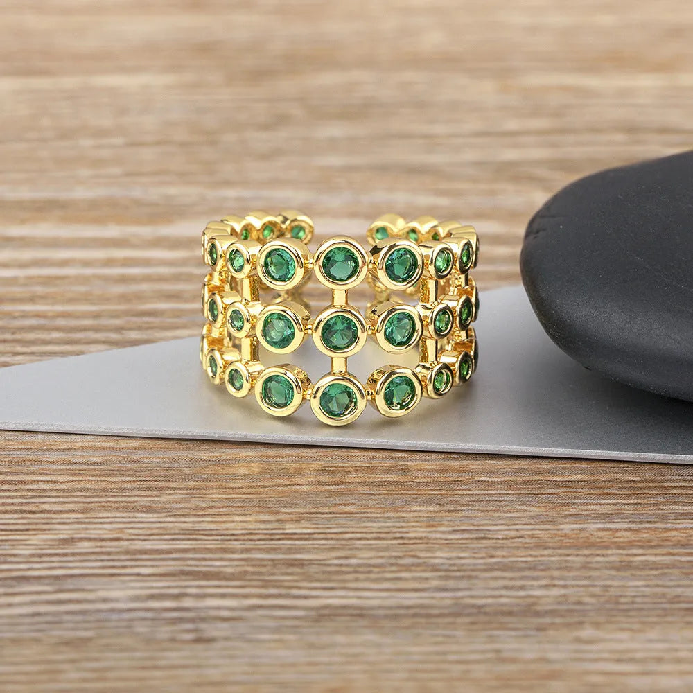 Copper wide band ring with 18K gold plating, green accents, and zircon stones