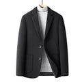 Men's slim fit wool suit jacket in grey, shown on a model, featuring a notched lapel and button front.