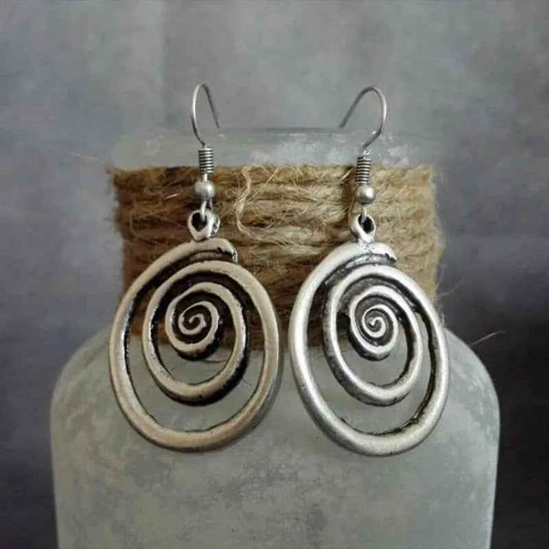 Geometric spiral distressed earrings in silver alloy with retro design measuring 2.6 by 5 cm