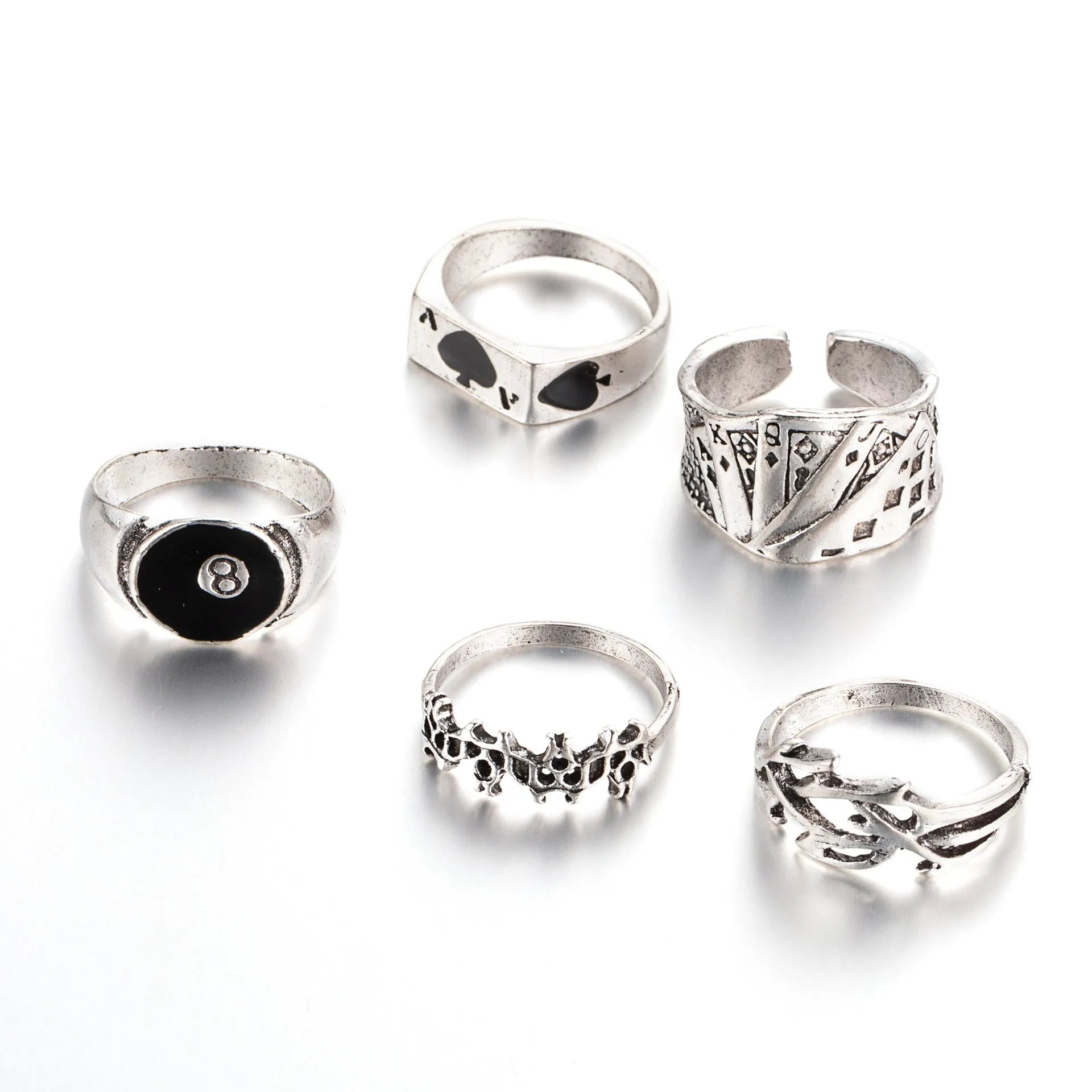 Black alloy ring with a detailed retro spade card design on a finger.