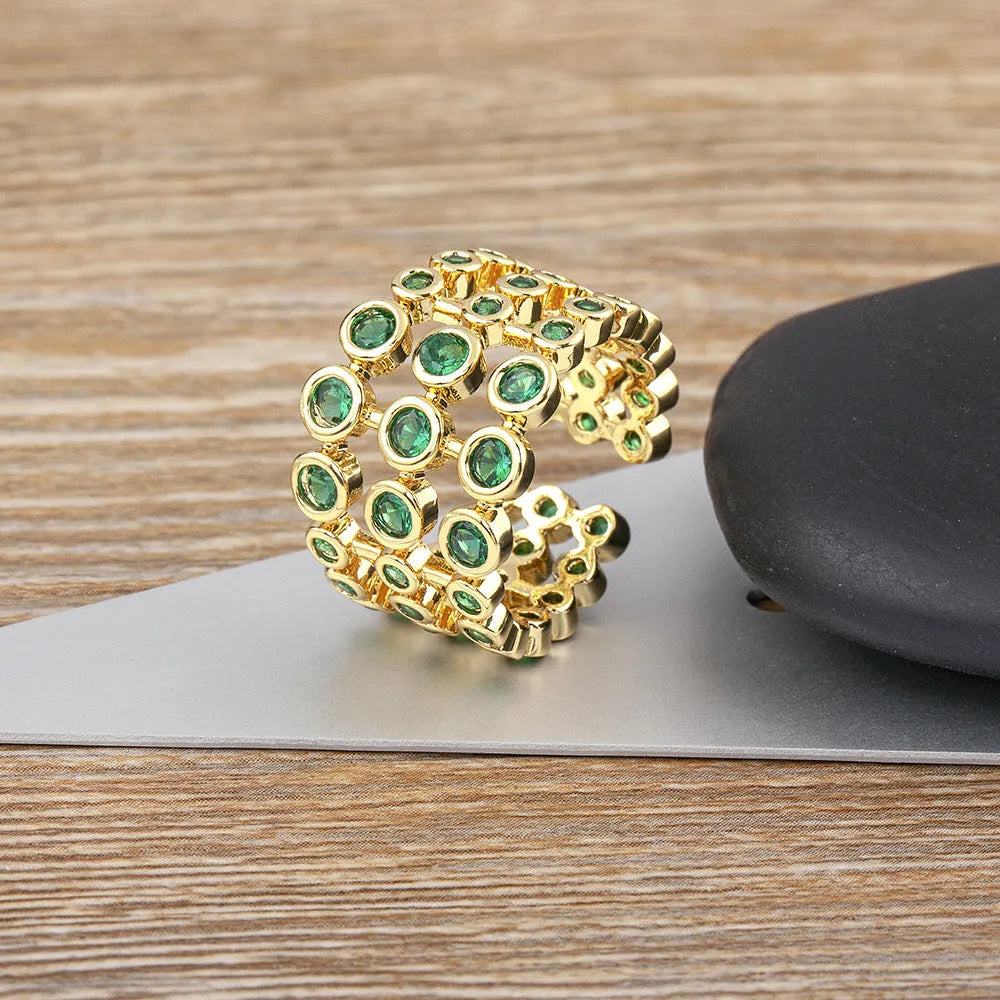 Copper wide band ring with 18K gold plating, green accents, and zircon stones