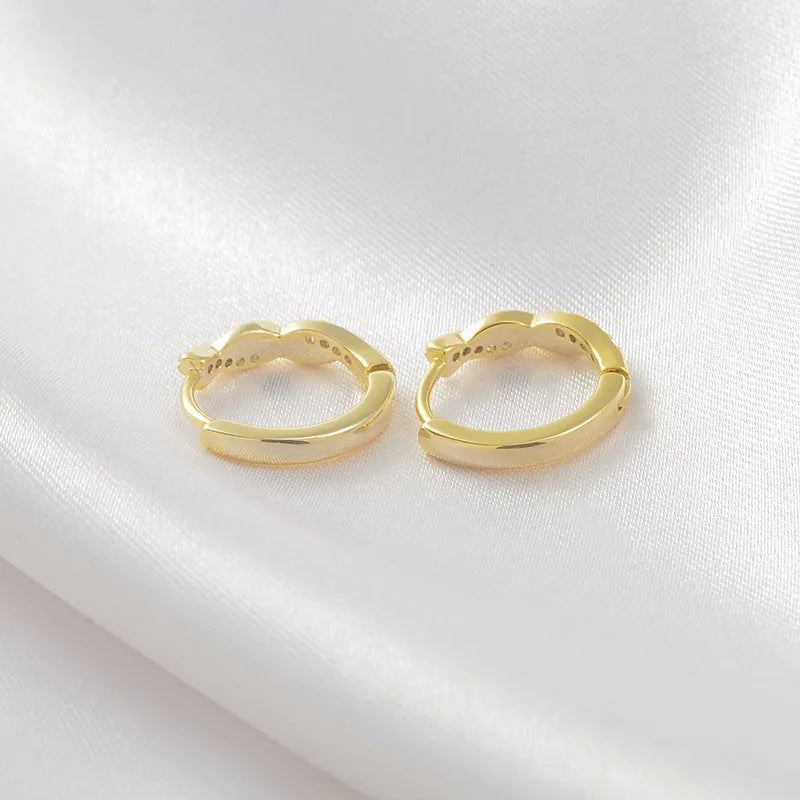 Geometric interwoven hemp rope earclip earrings in gold or silver colour on a copper base.