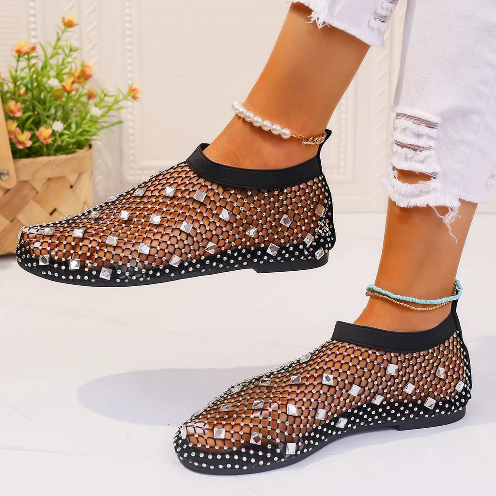 Women's flat sandals with mesh upper, colourful rhinestone design, and round toe on a rubber sole.