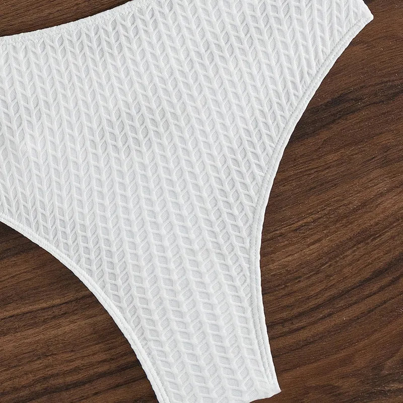 White women's backless two-piece bikini swimsuit set on a mannequin.