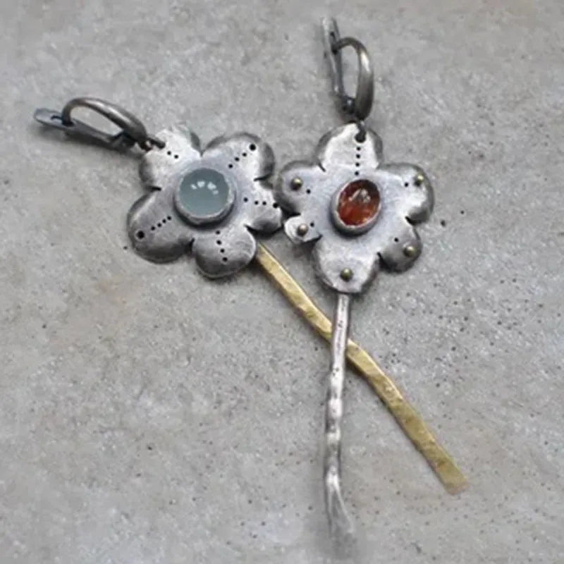 Geometric floral retro earrings with two-tone asymmetrical design and long drop style.