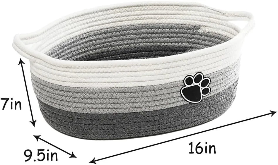 Small light beige woven cotton rope storage basket with a handle on a wooden surface