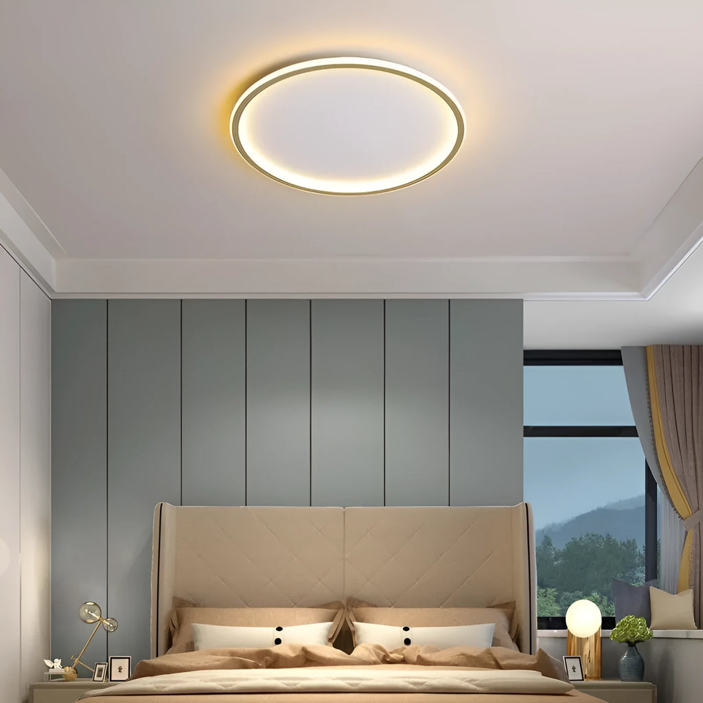 Minimalist round LED ceiling lamp in black finish with dimmable tricolour light, shown in a bedroom setting.