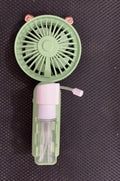 Small plastic USB desk fan with nozzle in apricot colour, shown with charging cable on a wooden desk.