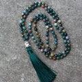 Natural agate bracelet with 108 geometric beads, each measuring 6mm, laid flat.