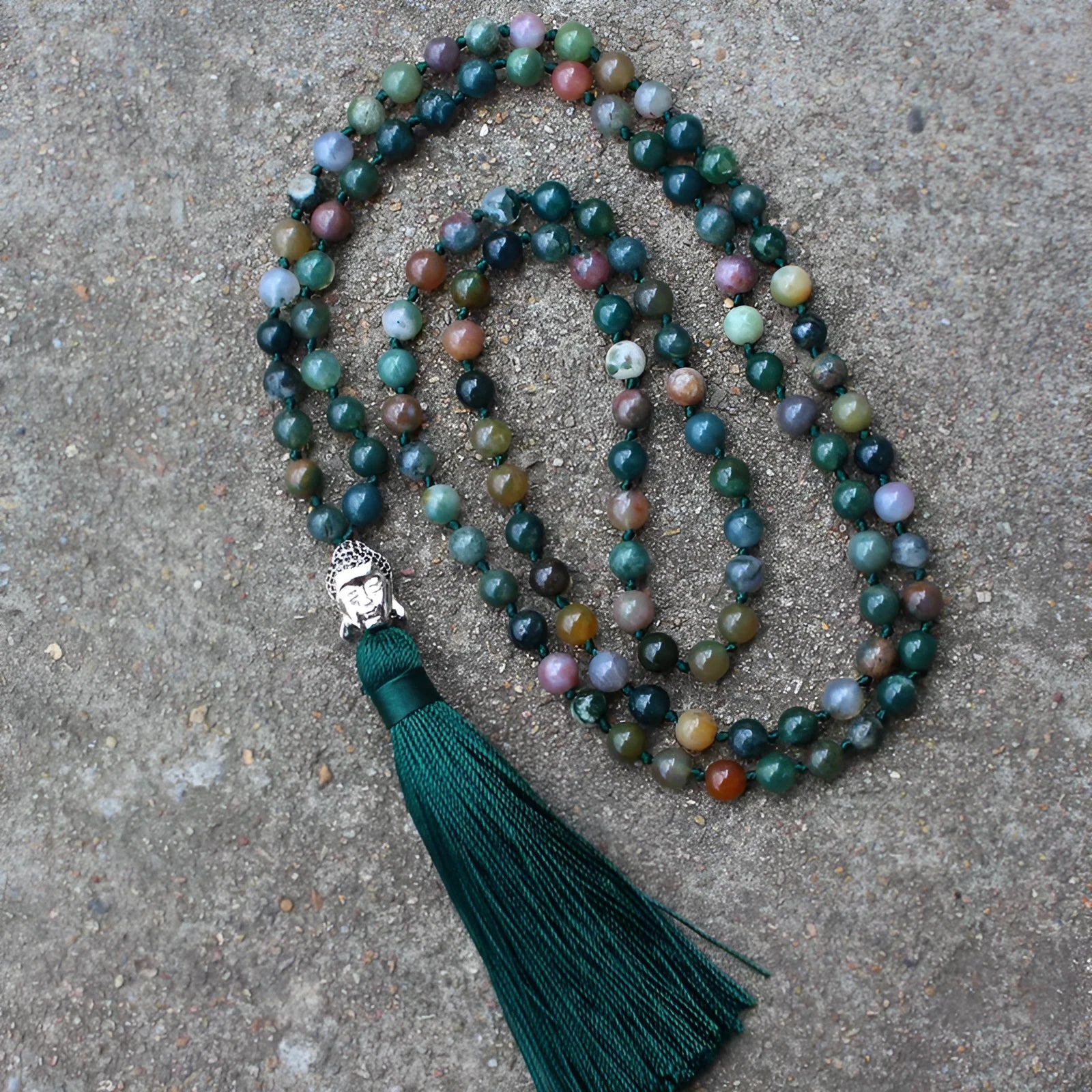 Natural agate bracelet with 108 geometric beads, each measuring 6mm, laid flat.