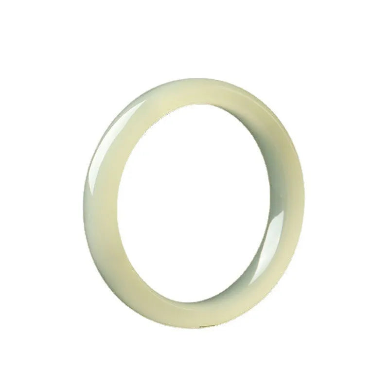 Close-up of a smooth, ice-like silk jade round bar bracelet on a wrist.