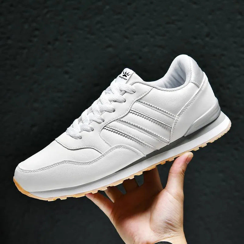 Men's black casual running shoes with a white carved wing pattern on the leather upper.