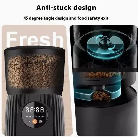 Black automatic pet feeder with digital display and stainless steel bowl on a kitchen floor.