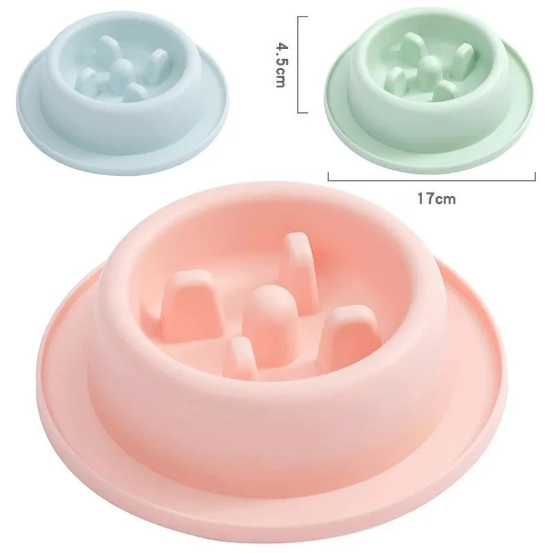 Blue pet slow feeder bowl with raised obstacles on a kitchen floor.