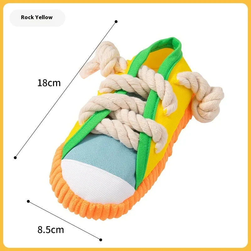 Yellow plastic dog slipper toy with a squeaker for chewing.