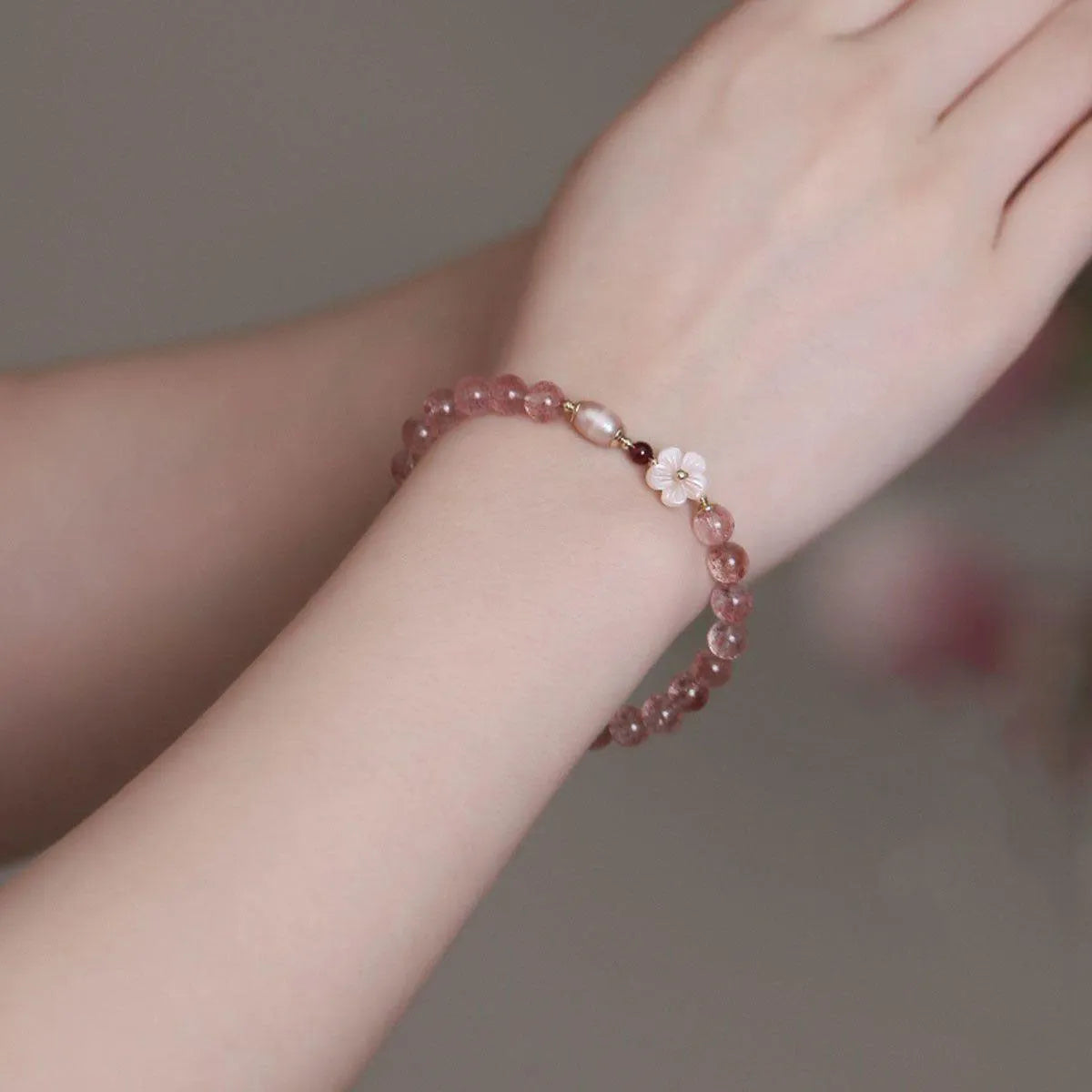 Strawberry quartz crystal bracelet with floral peach blossom design and silver-tone metal fittings
