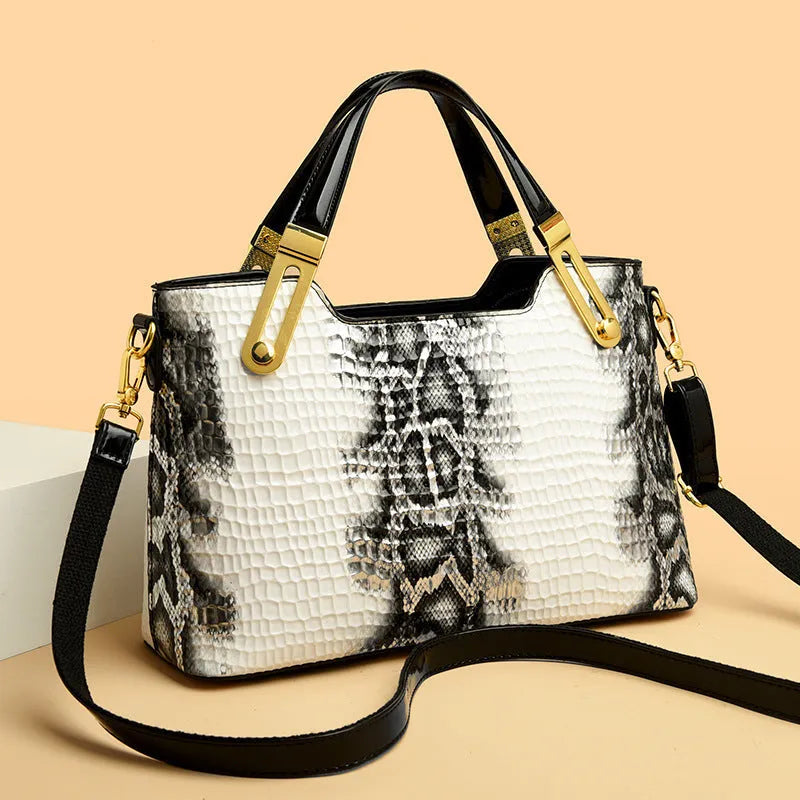 Retro black and white messenger bags with chain detail, showing internal phone and file compartments.