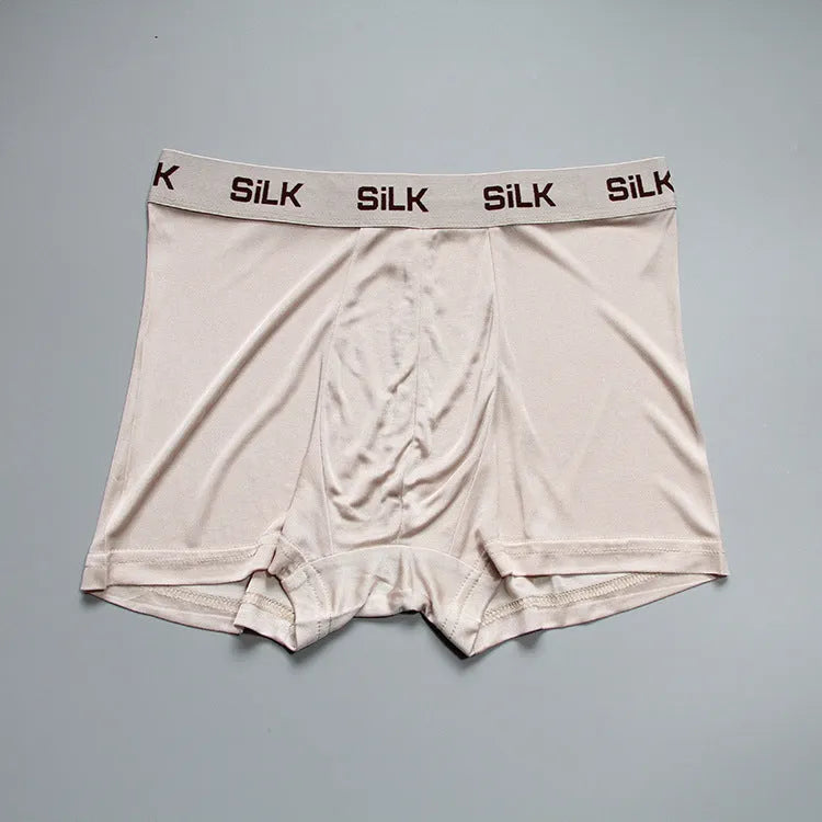 Men's loose-fitting silk shorts in navy blue, shown laid flat, featuring a mid waist and casual design.