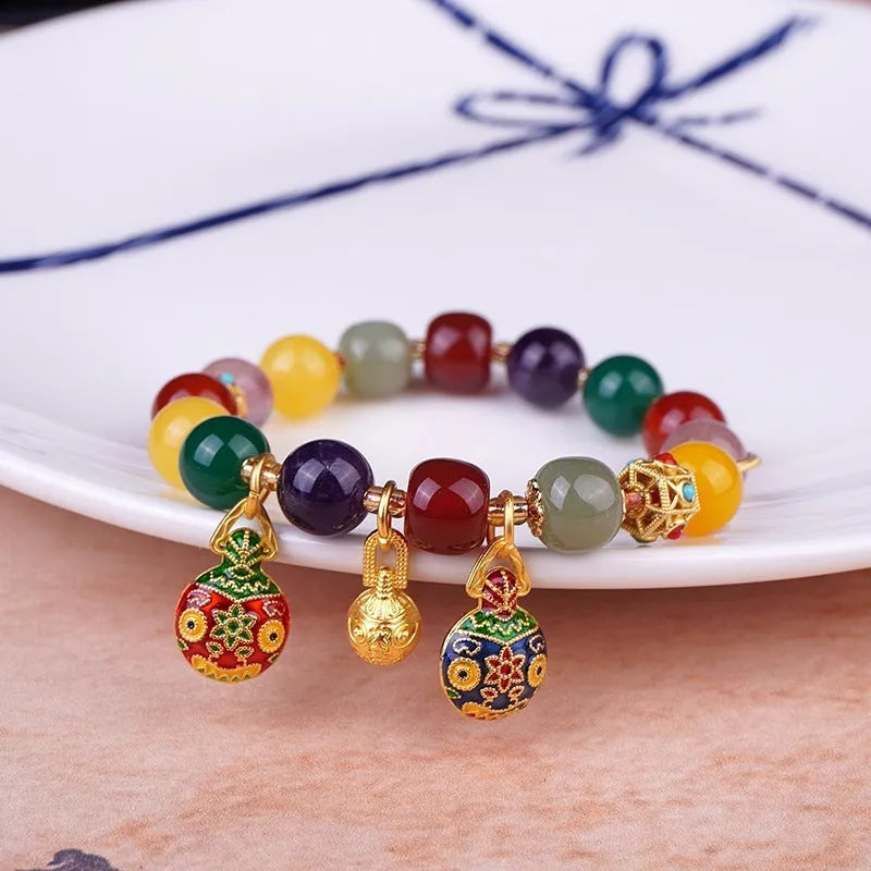 Hand-woven agate bracelet with gold and red Swallowing Gold Beast design on 10mm beads