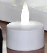 White plastic USB rechargeable LED candle lamp with flickering flame effect on wooden table