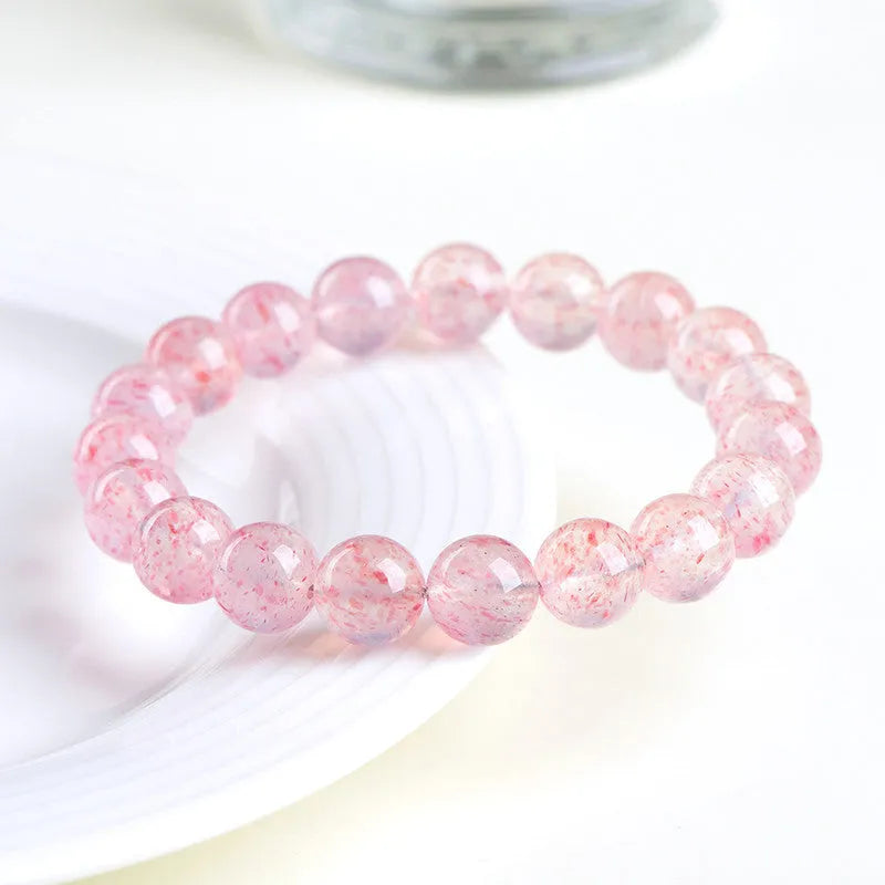 Strawberry quartz crystal bracelet with 10-10.8mm round beads in natural white water colour