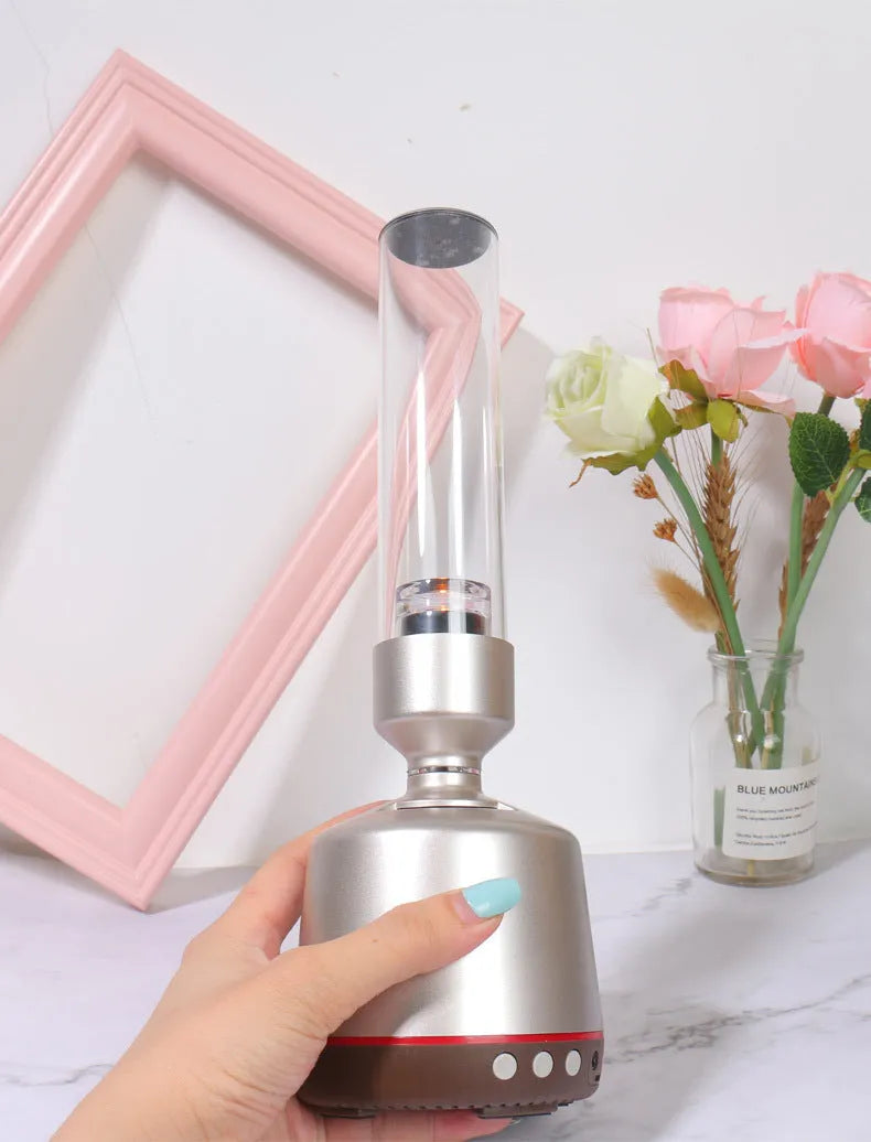 White silver cylindrical Bluetooth speaker night light with candlelight LED glow.