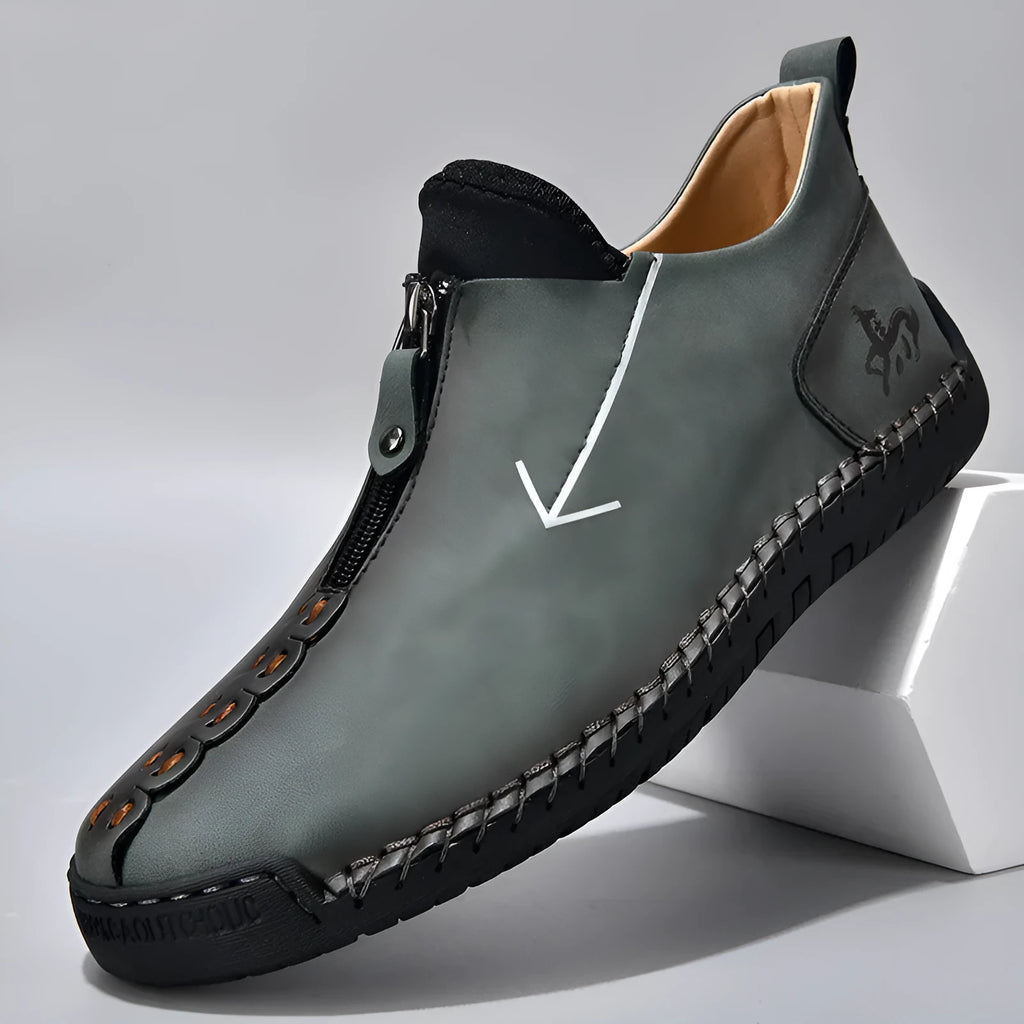 Men's black leather ankle boots with front zipper and round toe on rubber sole