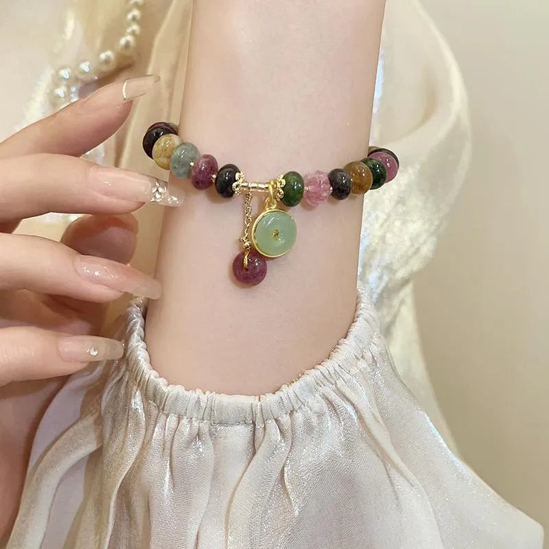 Colourful natural tourmaline abacus bead bracelet with a rabbit pendant charm.