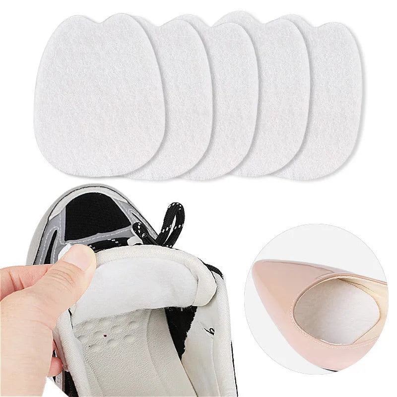 White thin felt shoe tongue stickers showing front pad design for anti-wear protection