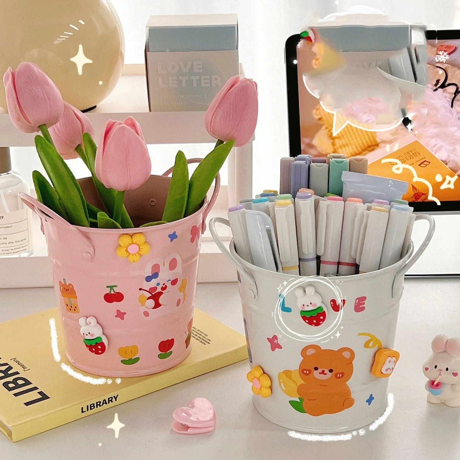 Round metal creative iron art pen holder on a desk, shown in a choice of solid colours or with sticker patch accents.