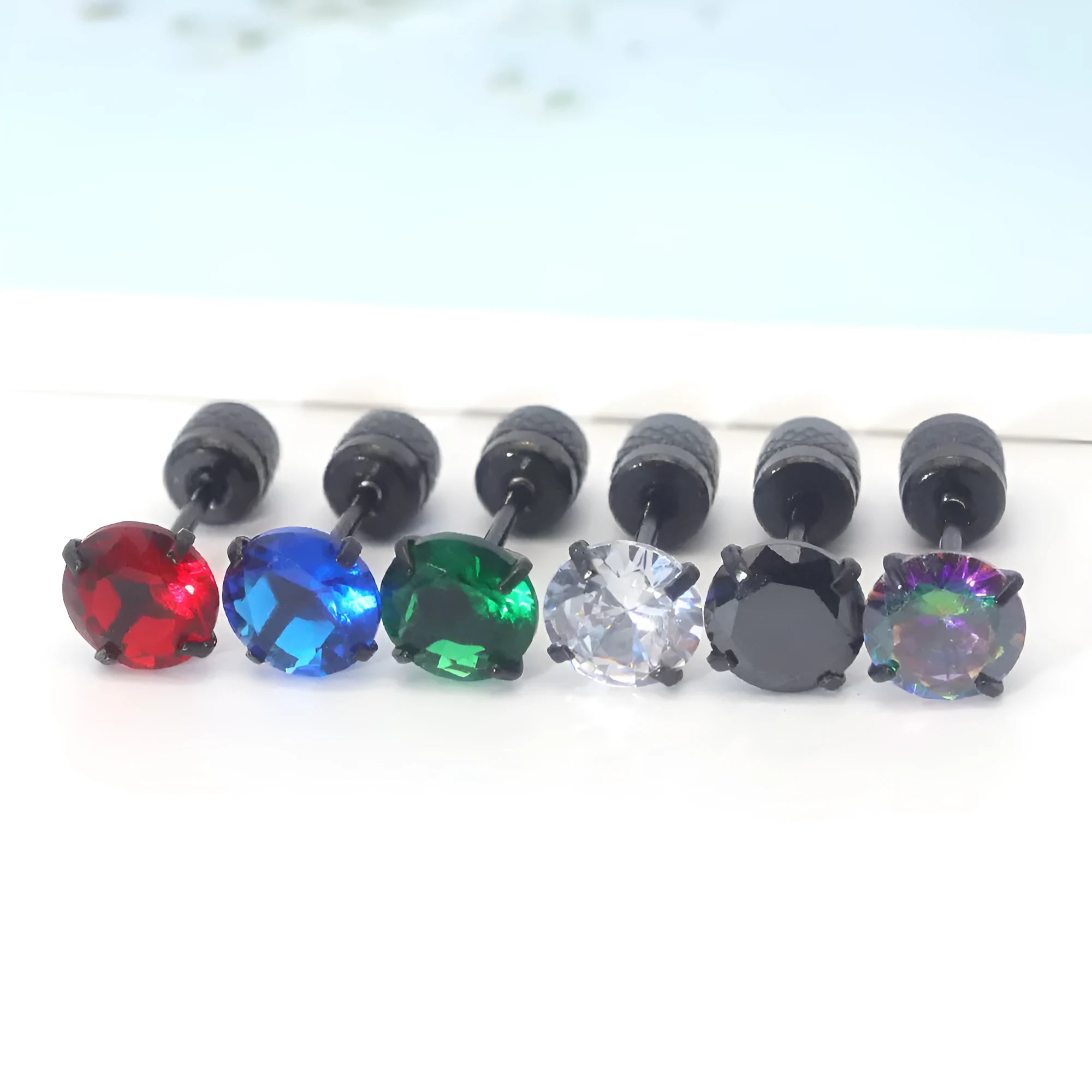 Geometric stainless steel zircon earrings in multiple sizes and colours with diamond treatment on a white background.