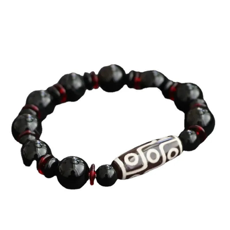 Black agate dzi bead bracelet with geometric 11mm beads on a hand-woven cord.
