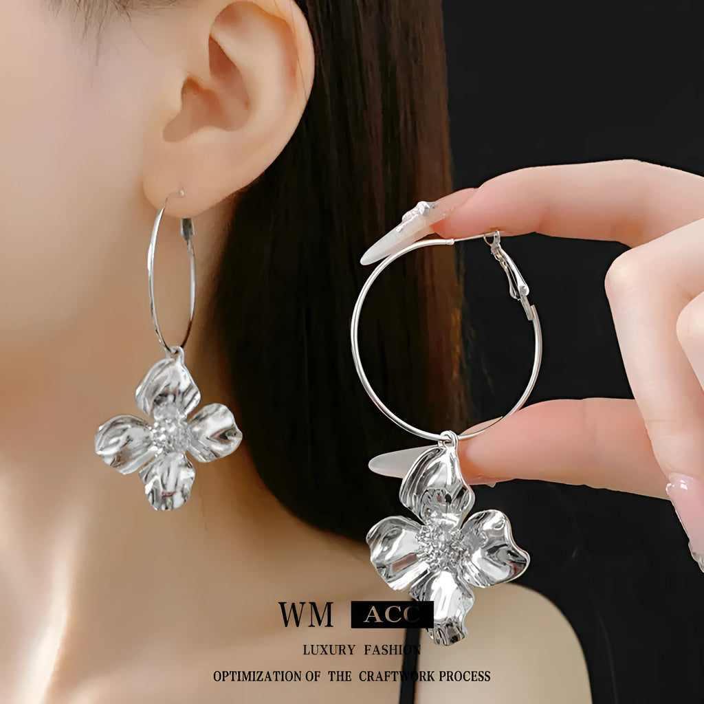 Gold and silver vintage metal flower earrings with geometric design and a silver needle detail.