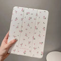 Transparent floral tri-fold iPad protective case showing magnetic stand function and cartoon design