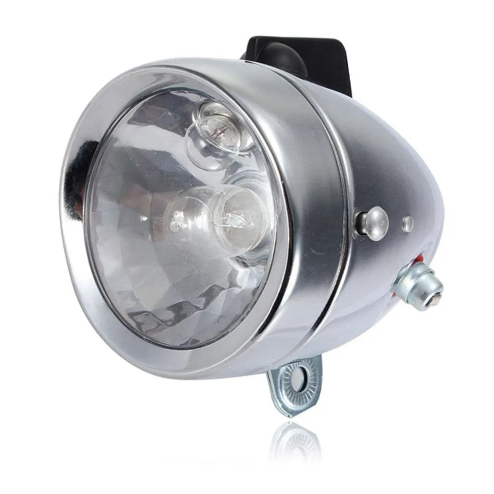 Silver bicycle dynamo-powered generator light kit mounted on a bicycle frame for front and rear lighting.