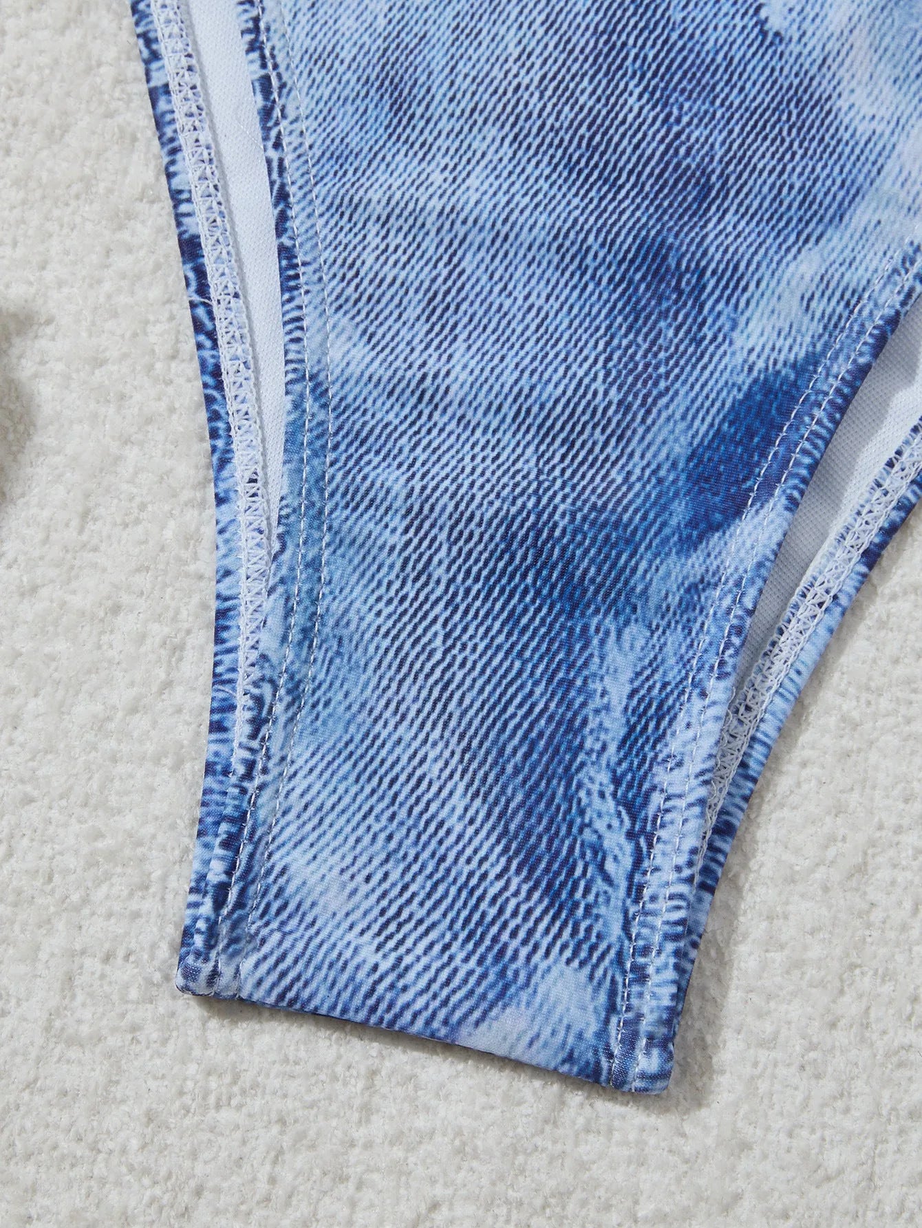 Denim blue printed women's bikini set with strap design on a white background.