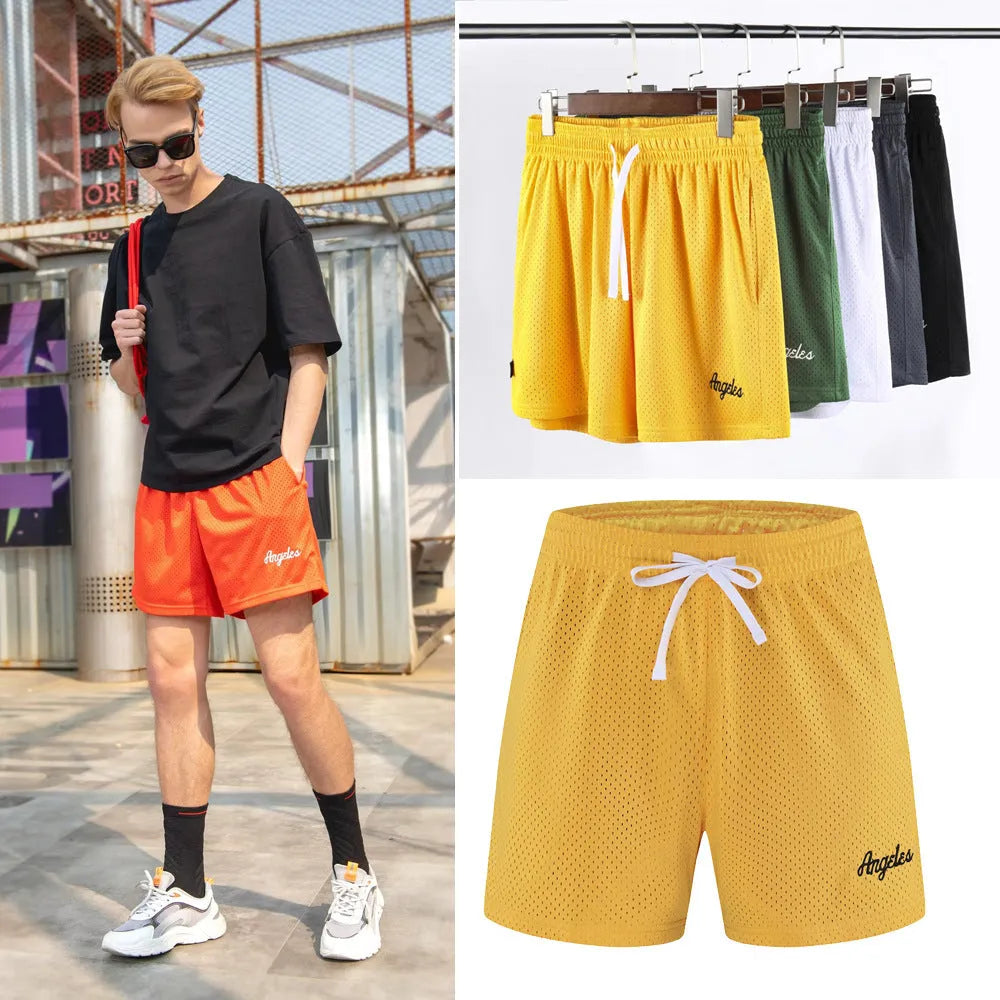Men's black double-layer mesh sport shorts laid flat, showing mesh panelling and elasticated waistband.