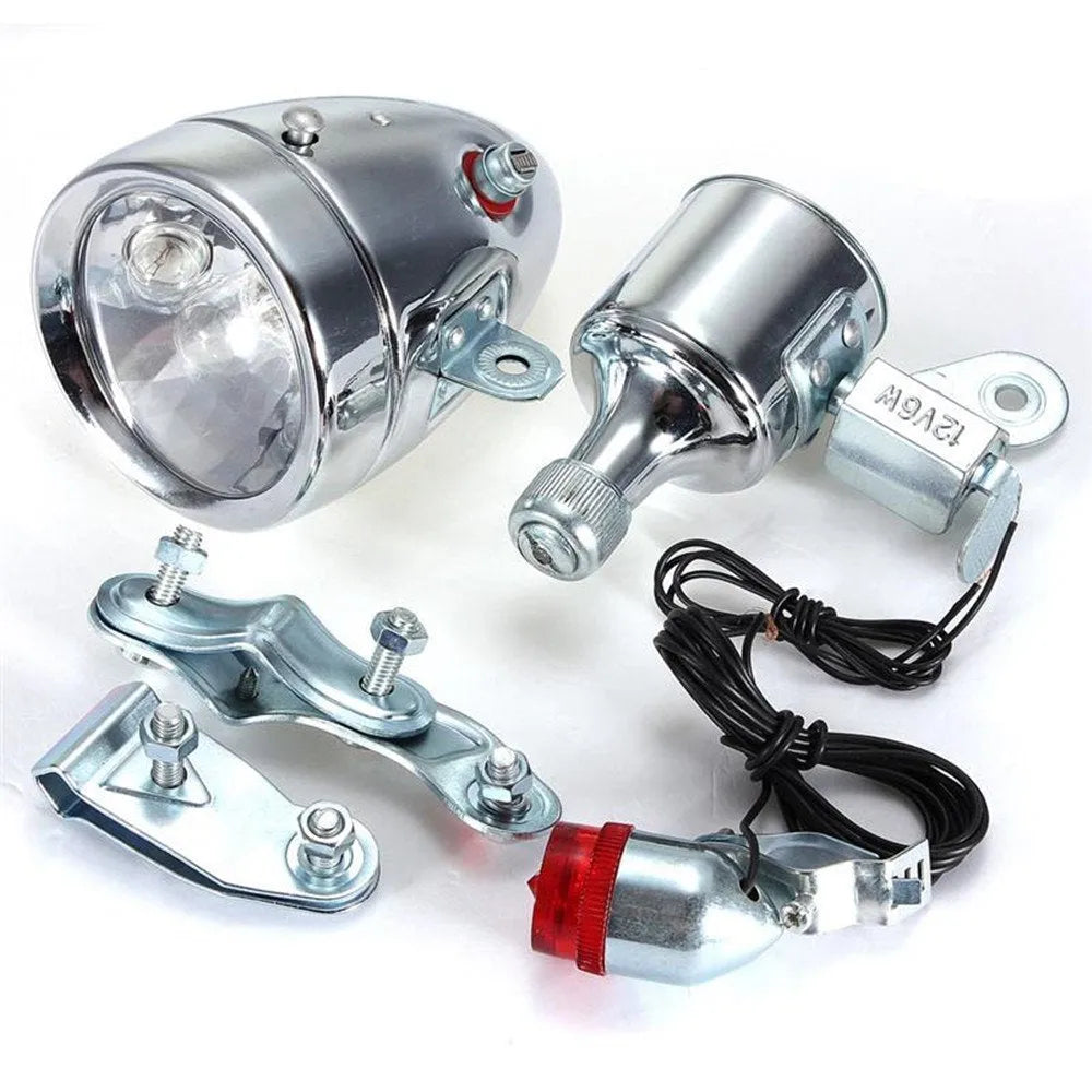 Silver bicycle dynamo-powered generator light kit mounted on a bicycle frame for front and rear lighting.