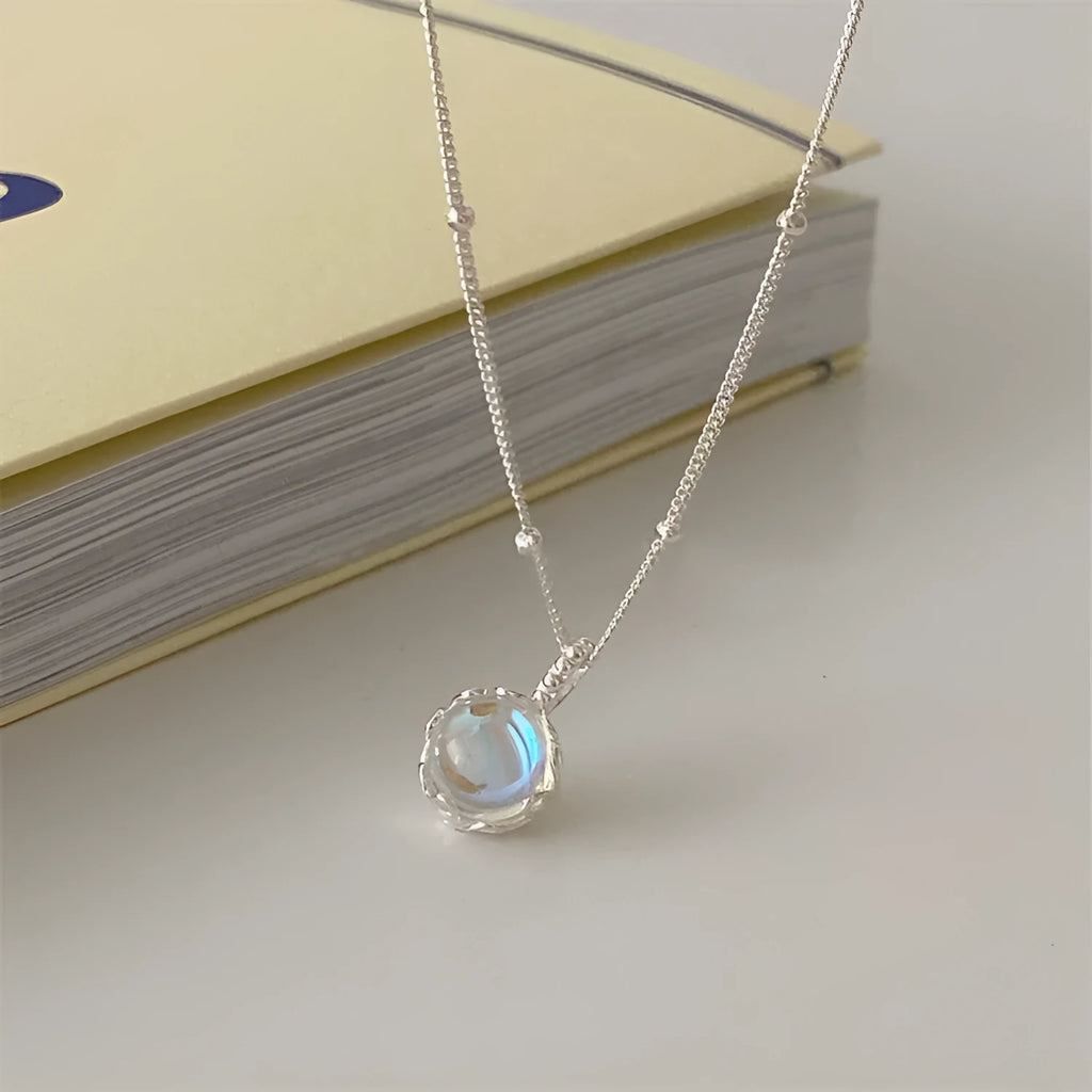 Silver 925 ornamental stone necklace with geometric pendant on a curb chain.