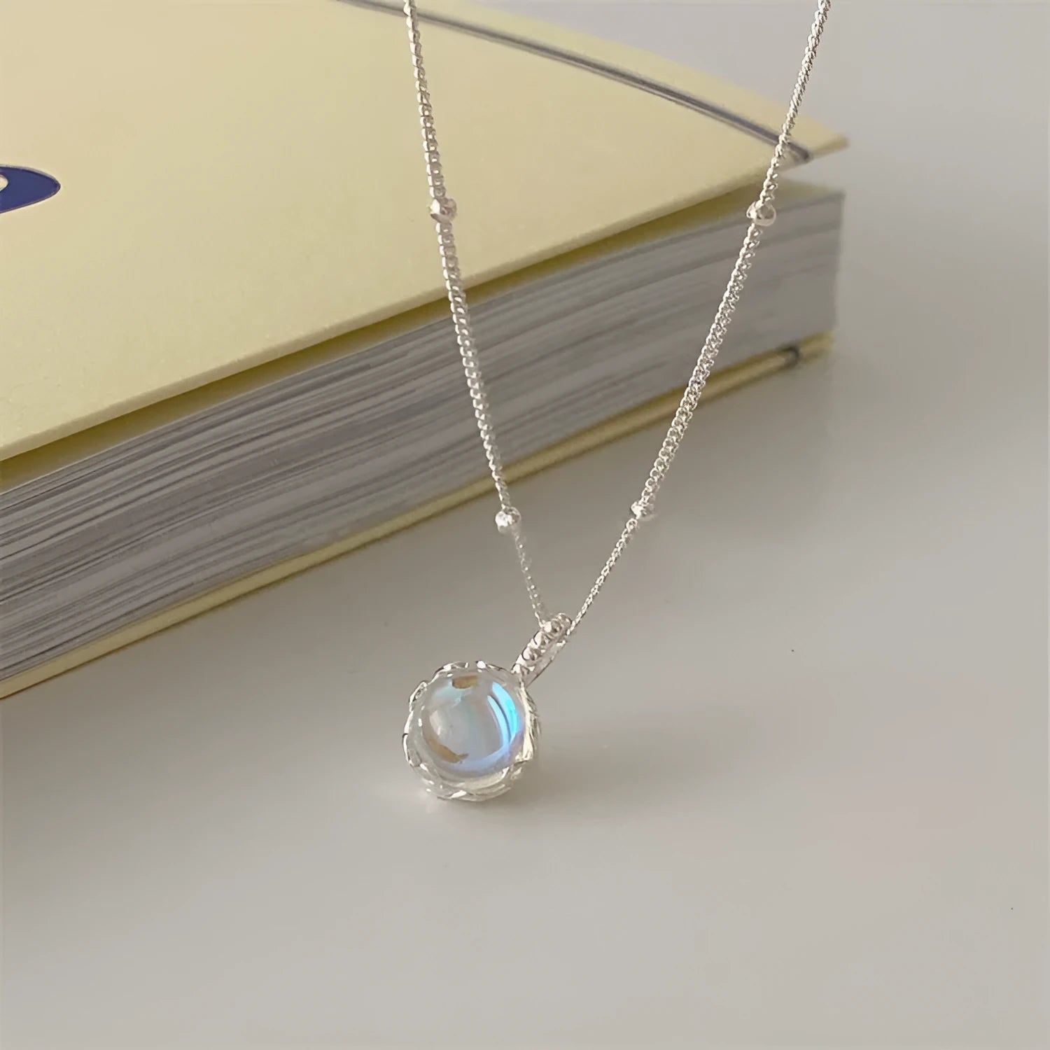 Silver 925 ornamental stone necklace with geometric pendant on a curb chain.