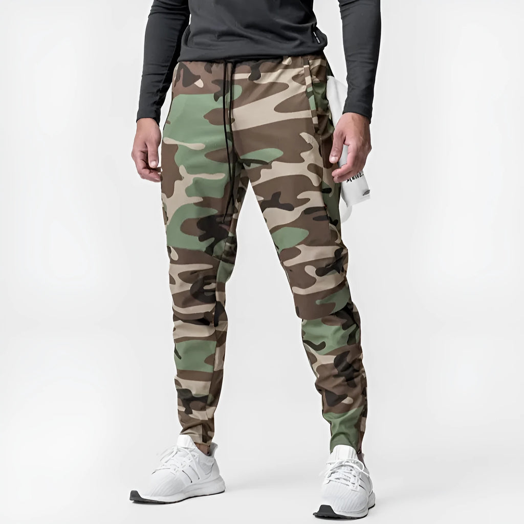 Man in loose grey fitness trousers with tied ankle cuffs, suitable for exercise.
