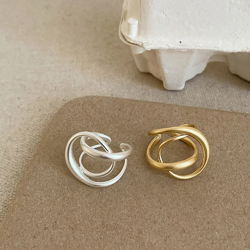 Women's geometric open ring with three-dimensional interlaced matte metal design in gold or silver with real gold electroplating
